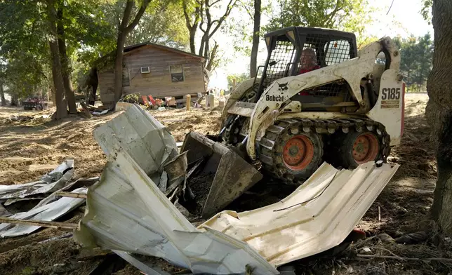 Debris left in the aftermath of Hurricane Helene is cleared Saturday, Oct. 5, 2024, in Del Rio, Tenn. (AP Photo/Jeff Roberson)