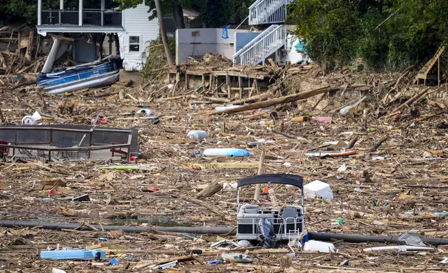 Debris is strewn on the lake in the aftermath of Hurricane Helene, Wednesday, Oct. 2, 2024, in Lake Lure, N.C. (AP Photo/Mike Stewart)