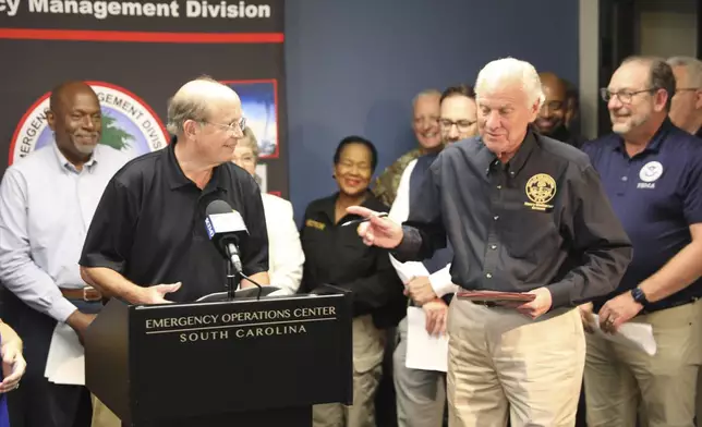 South Carolina Gov. Henry McMaster, right, asks a question of South Carolina Emergency Management Director Kim Stenson, left, during a news conference Thursday, Oct. 3, 2024, in West Columbia, S.C. (AP Photo/Jeffrey Collins)