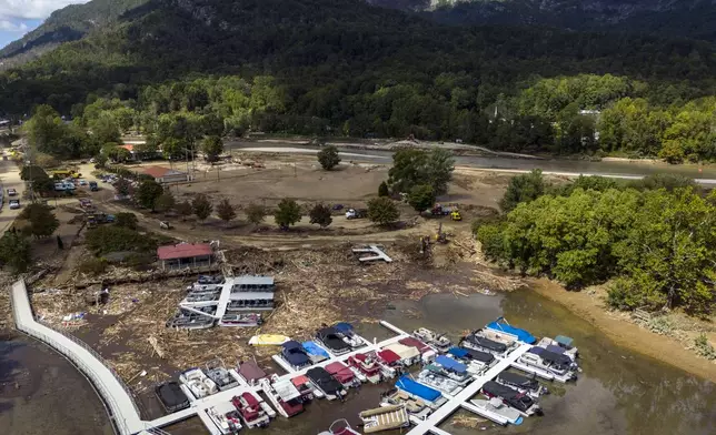 In this image taken with a drone, a marina is choked in debris in the aftermath of Hurricane Helene, Wednesday, Oct. 2, 2024, in Lake Lure, N.C. (AP Photo/Mike Stewart)