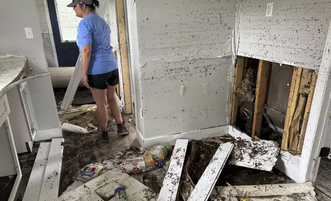 Brooke Hiers surveys the damage done to her home, Monday, Sept. 30, 2024, in Horseshoe Beach, Fla., in the aftermath of Hurricane Helene. Hiers and her husband rebuilt the home in the wake of Hurricane Idalia, which washed ashore in August, 2023, only to see it destroyed by another storm 13 months later. (AP Photo/Kate Payne)