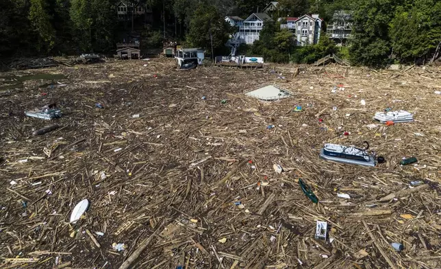 FILE - Debris is strewn on the lake in the aftermath of Hurricane Helene, Oct. 2, 2024, in Lake Lure, N.C. (AP Photo/Mike Stewart, File)