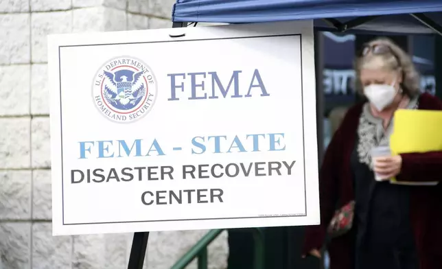 People gather at a FEMA Disaster Recovery Center at A.C. Reynolds High School in Asheville, N.C.,, Tuesday, Oct. 15, 2024. (AP Photo/Makiya Seminera)