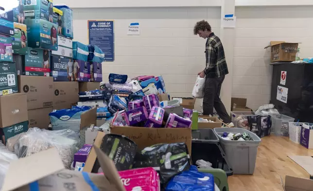 High school senior Nathan Flaherty packs hygiene kits for people in need of supplies as he volunteers in the aftermath of Hurricane Helene, Wednesday, Oct. 16, 2024, at the Dr. Wesley Grant Sr. Southside Community Center in Asheville, N.C. (AP Photo/Stephanie Scarbrough)