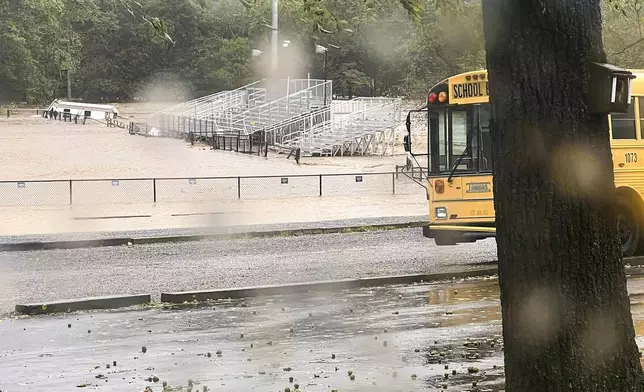 This photo provided by Kelly Benware shows flooding around the football field at Asheville Christian Academy in Swannanoa, N.C., on Friday, Sept. 27, 2024. (Kelly Benware via AP)