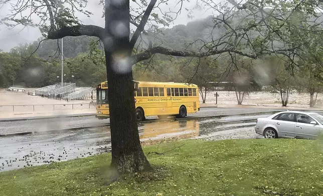 This photo provided by Kelly Benware shows flooding around the football field at Asheville Christian Academy in Swannanoa, N.C., on Friday, Sept. 27, 2024. (Kelly Benware via AP)