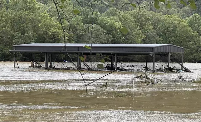 This photo provided by Kelly Benware shows flooding around the football field at Asheville Christian Academy in Swannanoa, N.C., on Friday, Sept. 27, 2024. (Kelly Benware via AP)