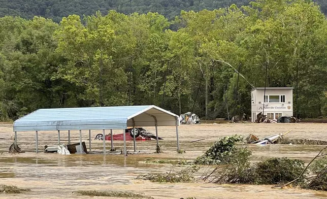 This photo provided by Kelly Benware shows flooding around the football field at Asheville Christian Academy in Swannanoa, N.C., on Friday, Sept. 27, 2024. (Kelly Benware via AP)