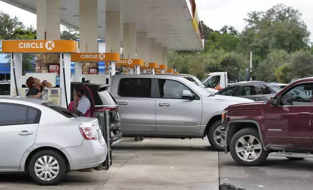 Motorists wait in line to fill gas tanks Monday, Oct. 7, 2024, in Riverview, Fla., before Hurricane Milton makes landfall along Florida's gulf coast. (AP Photo/Chris O'Meara)