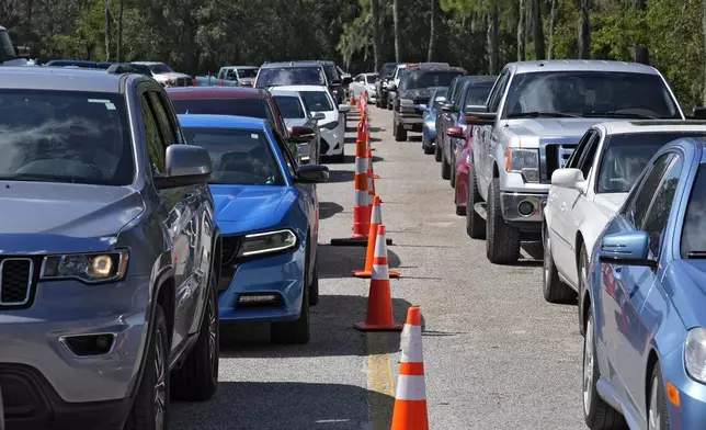 Motorists wait in long lines for fuel at a newly opened depot after Hurricane Milton Saturday, Oct. 12, 2024, in Plant City, Fla. (AP Photo/Chris O'Meara)