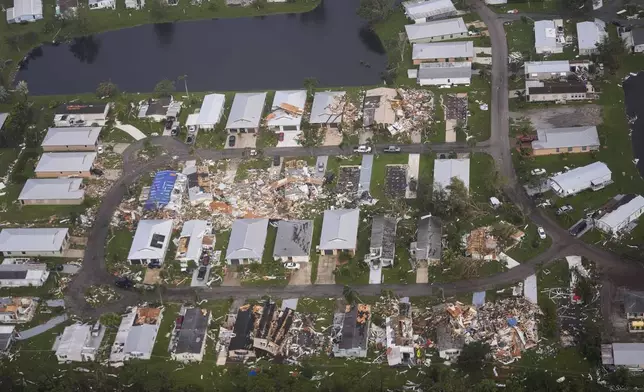 FILE - Neighborhoods with debris from tornadoes are visible in the aftermath of Hurricane Milton, Oct. 10, 2024, in Fort Pierce, Fla. (AP Photo/Gerald Herbert)