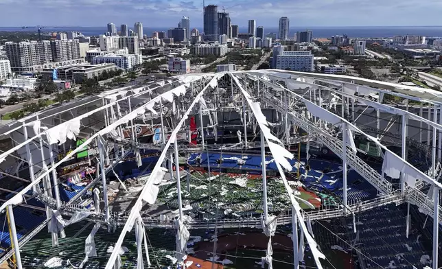 FILE - The roof of the Tropicana Field is damaged the morning after Hurricane Milton hit the region, Oct. 10, 2024, in St. Petersburg, Fla. (AP Photo/Mike Carlson, File)