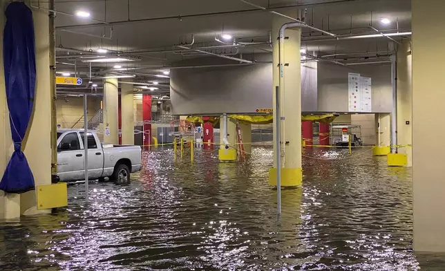 FILE - Flooding is seen at Tampa General Hospital as Tropical Storm Eta sends torrential downpours, storm surge flooding and wind across the Tampa Bay Area on Thursday, Nov. 12, 2020, in Tampa, Fla. (Luis Santana/Tampa Bay Times via AP)