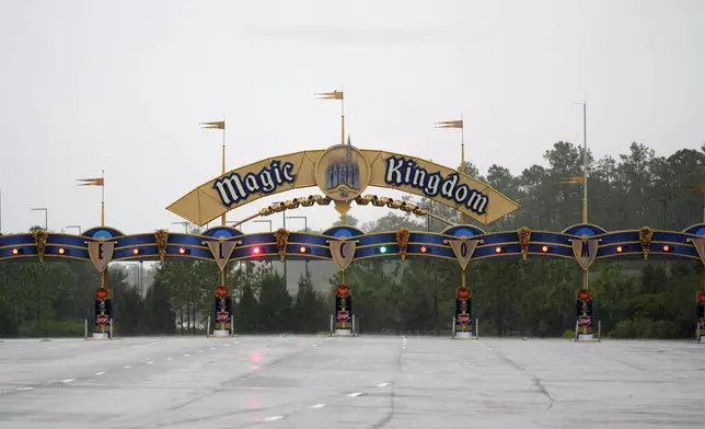 The entrance to the Magic Kingdom theme park is shown empty shortly before they closed because of the arrival of Hurricane Milton, Wednesday, Oct. 9, 2024, in Lake Buena Vista, Fla. (AP Photo/John Raoux)