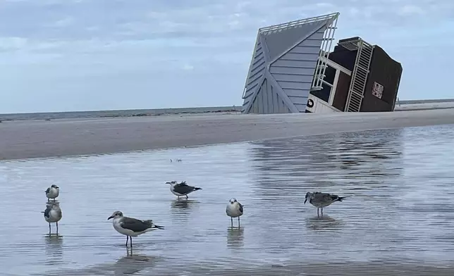 A lifeguard hut is on its side after Hurricane Milton at Clearwater Beach, Fla., on Friday, Oct. 11, 2024 (AP Photo/Haven Daley)