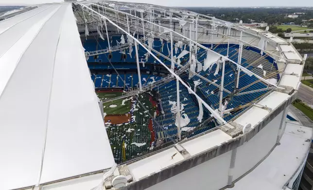 The roof of the Tropicana Field is seen damaged the morning after Hurricane Milton hit the region, Thursday, Oct. 10, 2024, in St. Petersburg, Fla. (AP Photo/Julio Cortez)