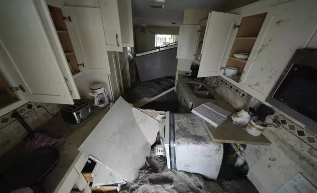 Several feet of sand fills a condo following the passage of Hurricane Milton, at YCA Vacation Rentals in Venice, Fla., Friday, Oct. 11, 2024. (AP Photo/Rebecca Blackwell)