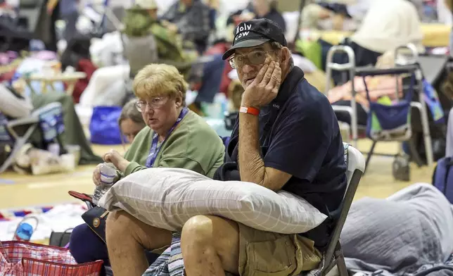 Stephen Gandy shelters in the gymnasium at River Ridge Middle/High School in preparation for Hurricane Milton, Wednesday, Oct. 9, 2024, in New Port Richey, Fla. (AP Photo/Mike Carlson)