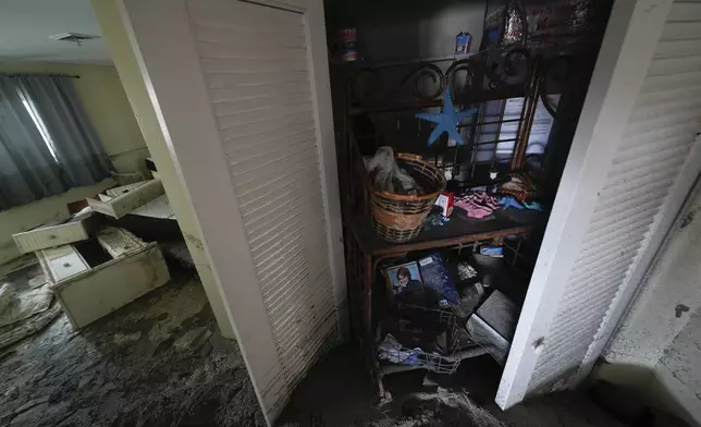 Several feet of displaced sand fills a condo following the passage of Hurricane Milton, at YCA Vacation Rentals in Venice, Fla., Friday, Oct. 11, 2024. (AP Photo/Rebecca Blackwell)