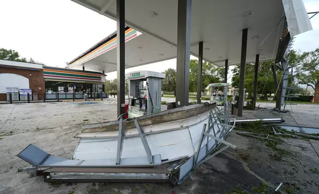 Debris and an awning of a gas station sits on the ground the morning after Hurricane Milton hit the region, Thursday, Oct. 10, 2024, in Tampa, Fla. (AP Photo/Julio Cortez)