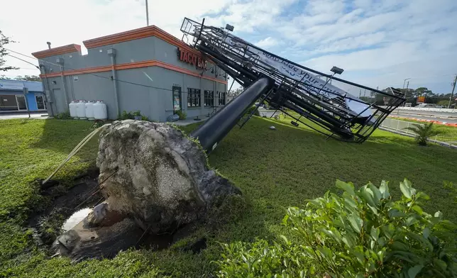 A billboard structure is seen after it was uprooted during Hurricane Milton, Thursday, Oct. 10, 2024, in Clearwater, Fla. (AP Photo/Julio Cortez)