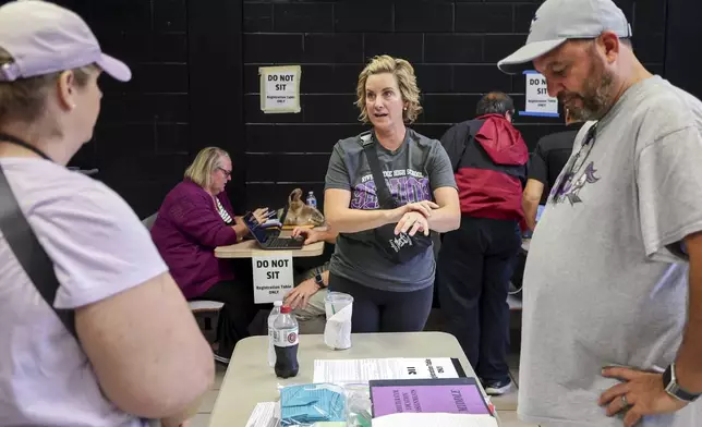 River Ridge High School principal Dr. Toni Zetzsche speaks with staff and volunteers as they ready the school for use as a shelter in preparation for Hurricane Milton on Monday, Oct. 7, 2024, in New Port Richey, Fla. (AP Photo/Mike Carlson)