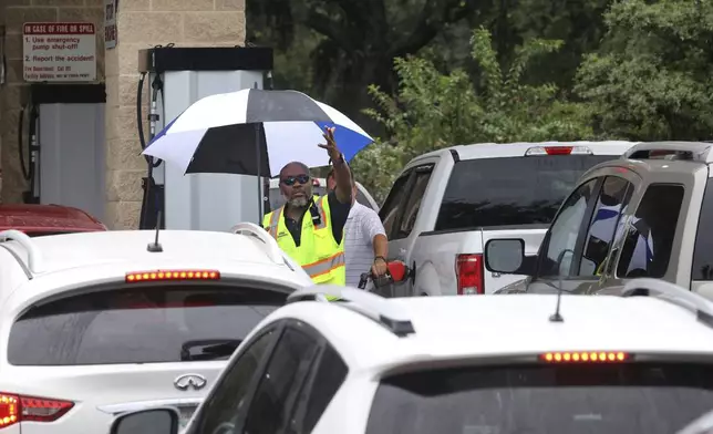 Cars wait in line to get into the parking lot for gas at Costco, Monday, Oct. 7, 2024, in Altamonte Springs, Fla., as residents prepare for the impact of approaching Hurricane Milton. (Joe Burbank/Orlando Sentinel via AP)