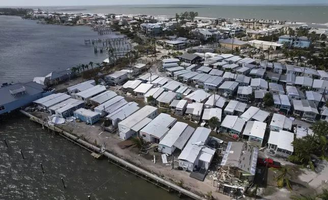 Mobile homes damaged by Hurricane Milton, at Pines Trailer Park in Bradenton Beach on Anna Maria Island, Fla., are shown onThursday, Oct. 10, 2024. (AP Photo/Rebecca Blackwell)