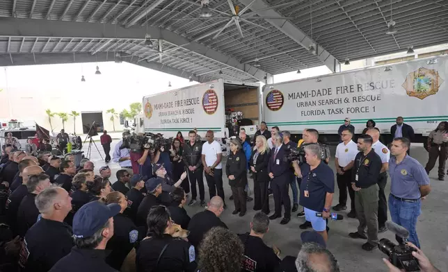 Miami-Dade County Mayor Daniella Levine Cava, center, addresses members of Miami-Dade Fire Rescue's Urban Search and Rescue Florida Task Force One before they deploy ahead of Hurricane Milton, Wednesday, Oct. 9, 2024, in Doral, Fla. (AP Photo/Wilfredo Lee)