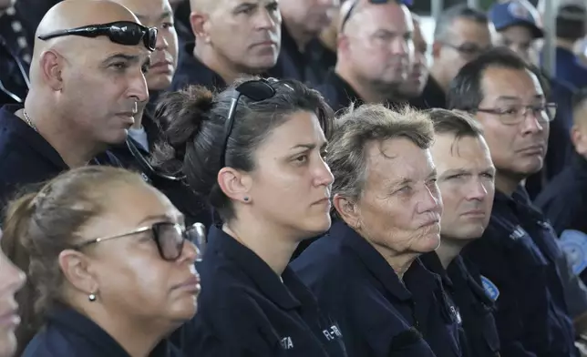 Members of Miami-Dade Fire Rescue's Urban Search and Rescue Florida Task Force One are addressed by officials before they deploy ahead of Hurricane Milton, Wednesday, Oct. 9, 2024, in Doral, Fla. (AP Photo/Wilfredo Lee)