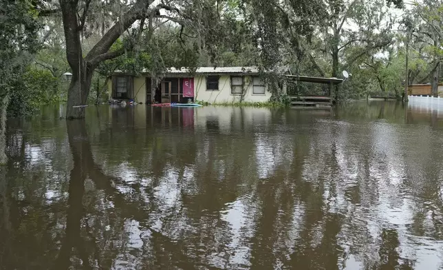 A flooded home, from the effects of Hurricane Milton is shown along the Alafia river Friday, Oct. 11, 2024, in Lithia, Fla. (AP Photo/Chris O'Meara)