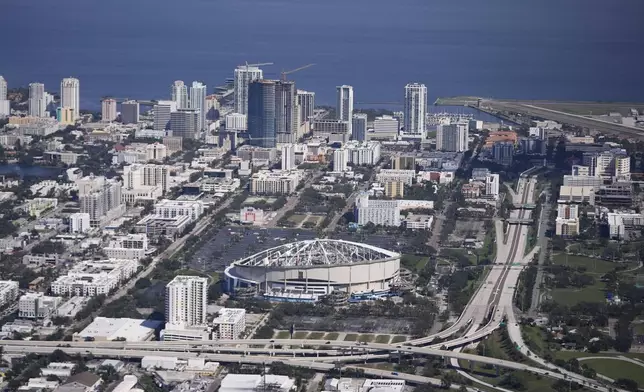 The destroyed roof of the Tropicana Dome is seen in the aftermath of Hurricane Milton, Thursday, Oct. 10, 2024, in St. Petersburg, Fla. (AP Photo/Gerald Herbert)