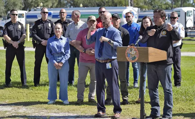 Florida Gov. Ron DeSantis, second from right, gestures as he holds a news conference after Hurricane Milton at a fuel depot Saturday, Oct. 12, 2024, in Plant City, Fla. (AP Photo/Chris O'Meara)