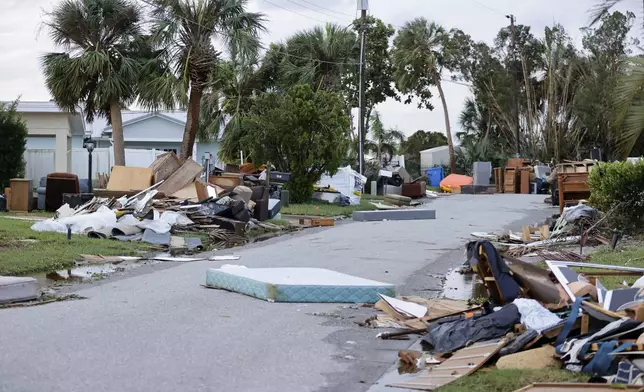 Debris left over from Hurricane Helene is pictured on the side of a road near Bahia Beach, in the aftermath of Hurricane Milton, on Thursday, Oct. 10, 2024 in Ruskin, Fla. (Luis Santana/Tampa Bay Times via AP)