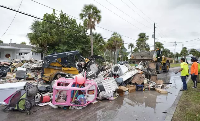 Salvage works remove debris from Hurricane Helene flooding along the Gulf of Mexico before approaching Milton, Monday, Oct. 7, 2024, in Clearwater Beach, Fla. (AP Photo/Chris O'Meara)