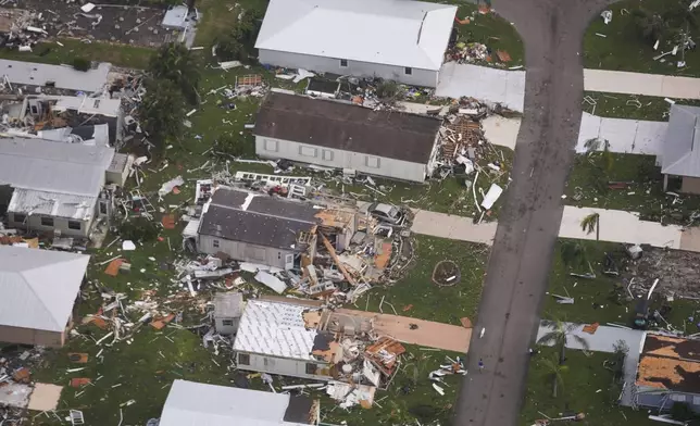 Neighborhoods destroyed by tornadoes are seen in this aerial photo in the aftermath of Hurricane Milton, Thursday, Oct. 10, 2024, in Fort Pierce, Fla. (AP Photo/Gerald Herbert)