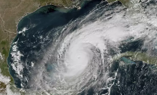 This GOES-16 GeoColor satellite image taken at 12:15 p.m. EDT and provided by National Oceanic and Atmospheric Administration (NOAA) shows Hurricane Milton in the Gulf of Mexico, off the coast off Mexico’s Yucatan Peninsula Tuesday, Oct. 8, 2024. (NOAA via AP)