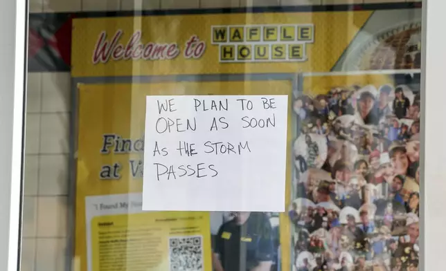 A sign on a closed Waffle House on Highway US 19 in anticipation of Hurricane Milton on Tuesday, Oct. 8, 2024, in New Port Richey, Fla. (AP Photo/Mike Carlson)