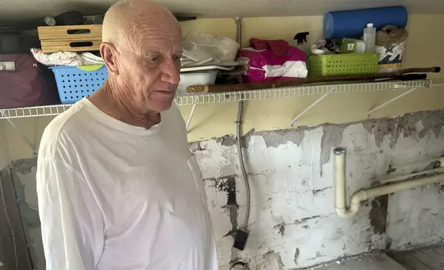 Mark Praught stands inside his storm-damaged home from Hurricane Milton in Cortez, Fla., on Saturday, Oct. 12, 2024. (AP Photo/Russ Bynum)