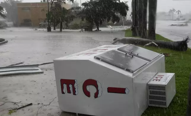 An apparent tornado caused by Hurricane Milton tossed an ice machine into the parking lot of a 7-Eleven convenient store, Wednesday, Oct. 9, 2024, in Cape Coral, Fla. (AP Photo/Marta Lavandier)