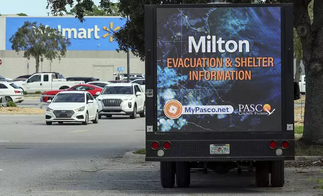 An LED signage truck with loudspeakers makes announcements informing residents of mandatory evacuations in preparation for Hurricane Milton on Tuesday, Oct. 8, 2024, in Port Richey, Fla. (AP Photo/Mike Carlson)