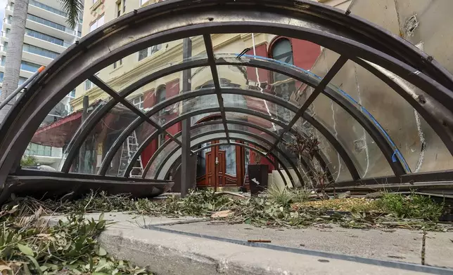 The awning from the Ponce de Leon Hotel sits on the ground after being damaged by winds from Hurricane Milton on Thursday, Oct. 10, 2024, in St. Petersburg, Fla. (AP Photo/Mike Carlson)