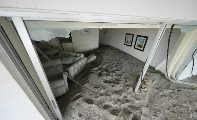 Several feet of sand fills a condo following the passage of Hurricane Milton, at YCA Vacation Rentals in Venice, Fla., Friday, Oct. 11, 2024. (AP Photo/Rebecca Blackwell)