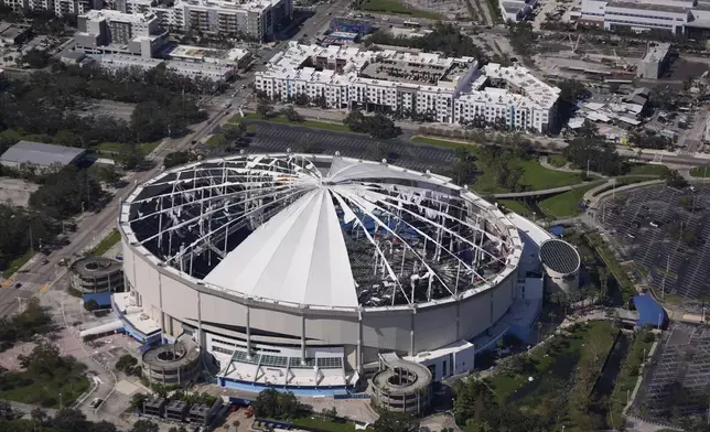 The destroyed roof of the Tropicana Dome is seen in the aftermath of Hurricane Milton, Thursday, Oct. 10, 2024, in St. Petersburg, Fla. (AP Photo/Gerald Herbert)