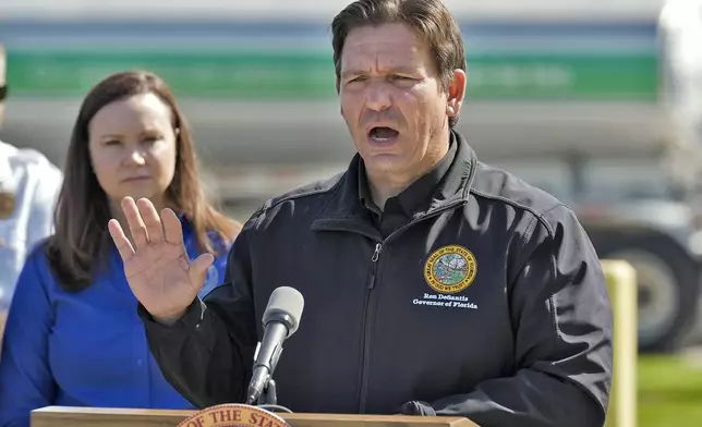 Florida Gov. Ron DeSantis holds a news conference at a fuel depot in Plant City, Fla., Saturday, Oct. 12, 2024, accompanied by Florida Attorney General Ashley Moody, right. Gas station are slow to open after the effects of Hurricane Milton. (AP Photo/Chris O'Meara)