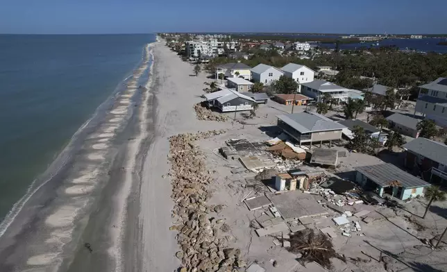 Foundations and debris remain after buildings were swept from their foundations and destroyed during Hurricane Milton, on Manasota Key, in Englewood, Fla., Sunday, Oct. 13, 2024. (AP Photo/Rebecca Blackwell)