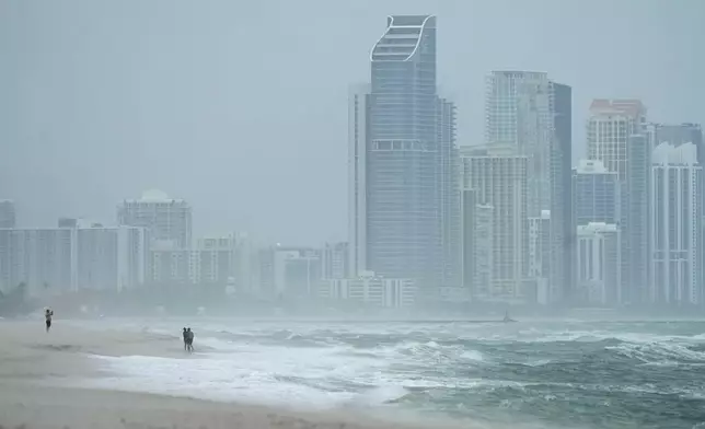 The city of Sunny Isles Beach, Fla., is seen from Surfside, Fla., as the outer bands of Hurricane Milton kick up the sand, Wednesday, Oct. 9, 2024. (AP Photo/Wilfredo Lee)