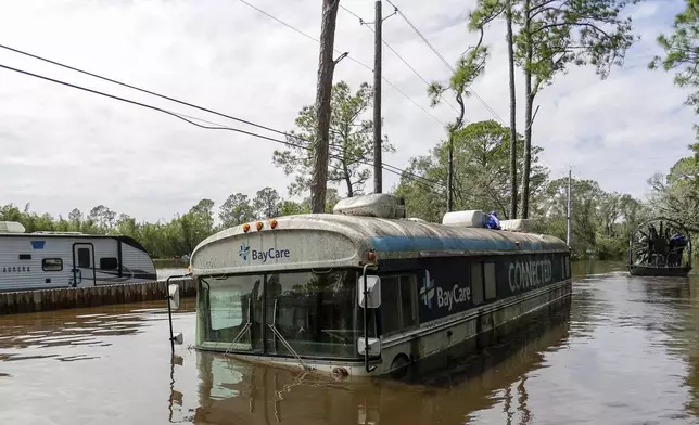 Vehicles and homes in a community inundated by historic flooding of the Alafia River due to Hurricane Milton are seen on Friday, Oct. 11, 2024 in Lithia, Fla. (Luis Santana/Tampa Bay Times via AP)