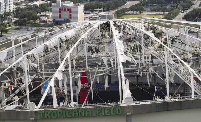 An aerial drone view shows Tropicana Field with the roof damaged after Hurricane Milton in downtown St. Petersburg, Fla., on Thursday, Oct. 10, 2024. (Dirk Shadd/Tampa Bay Times via AP)