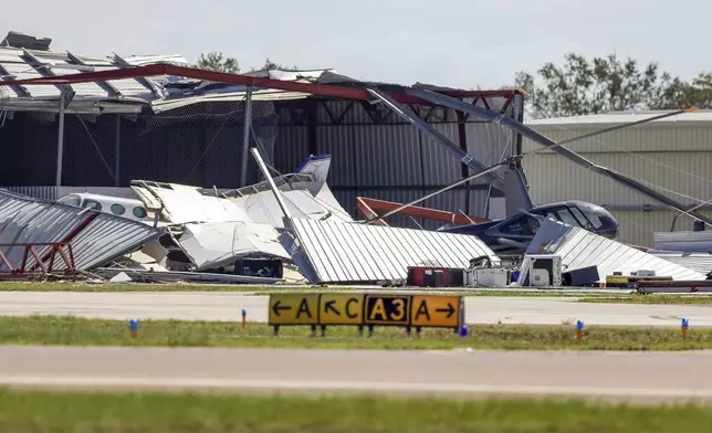 Hangars at Albert Whitted Airport were damaged by winds from Hurricane Milton on Thursday, Oct. 10, 2024, in St. Petersburg, Fla. (AP Photo/Mike Carlson)